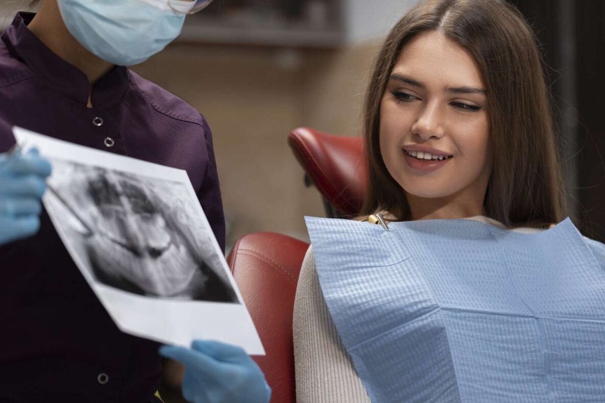 Dentist reviewing a dental X-ray with a patient